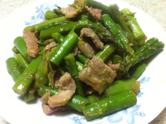 Măng tây xào thịt heo trình bày ra đĩa với sự hoàn hảo về độ bóng của dầu mè và màu sắc tự nhiên