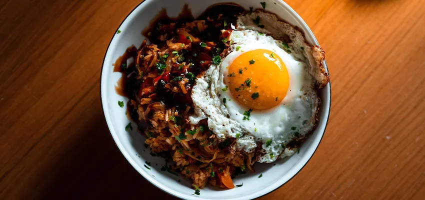 Cơm chiên kim chi (Kimchi-bokkeumbap 김치볶음밥) đỏ rực kích thích vị giác với trứng ốp la lòng đào.