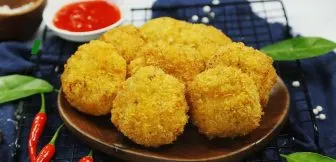 Rổ bánh gà vàng óng, giòn tan vừa mới được vớt ra khỏi chảo dầu nóng