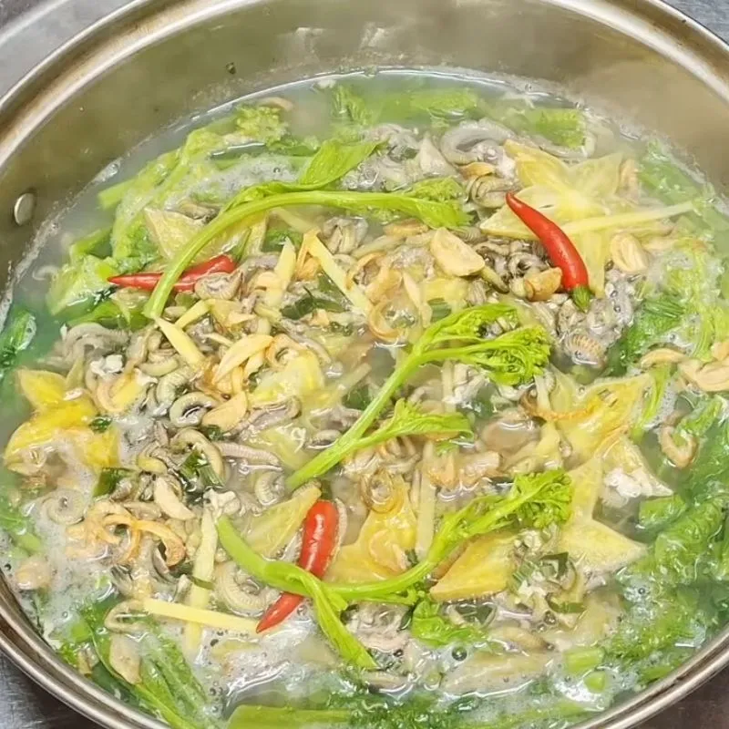 Canh rươi rau cải đắng với rươi đỏ tươi, rau xanh mướt trong nước dùng trong vắt