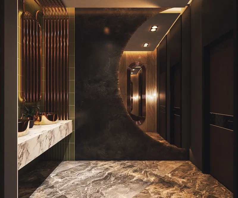 Sử dụng đá tự nhiên, kính cường lực, gỗ veneer và inox bóng giúp không gian vừa sang trọng vừa dễ vệ sinh, nâng cao trải nghiệm khách hàng